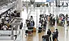 People line up to travel abroad at Incheon International Airport on Friday afternoon. [NEWS1]