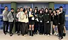 The national team's short track speed skaters and coaches pose for a photo as they celebrate the birthday of Shim Suk-hee, center, in Milan on Feb. 1. Choi Min-jeong stands third from right. [NEWS1]