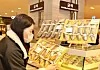 A model looks at a dried yellow corvina gift package at a Lotte Department Store branch. According to Lotte Department Store, sales of yellow corvina gift packages between Jan. 18 to Jan. 30 spiked 115 percent compared to the same period a year earlier. [LOTTE DEPARTMENT STORE]