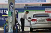 A customer pumps gas at a station in Seoul. [YONHAP]