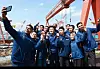 HD Hyundai Chairman Kwon Oh-gap, center, poses for a photo with foreign workers following a luncheon aimed at fostering inclusivity and addressing the needs of the workforce at HD Hyundai Heavy Industries' reception hall in Ulsan on Wednesday. [HD HYUNDAI]