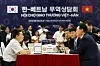Korean President Yoon Suk Yeol, right, encourages businesses at a trade consultation booth at the Korea-Vietnam Partnership Fair at a convention center in Hanoi Thursday as he kicked off a three-day state visit to Vietnam. [JOINT PRESS CORPS]