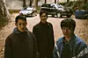Private An Jun-ho (played by Jung Hae-in), left, and Corporal Han Ho-yeol (played by Koo Kyo-hwan) in front, and their superior Park Bum-gu (played by actor Kim Sung-kyun) attempt to locate an escapee, a Private First Class named Cho Suk-bong. [NETFLIX]