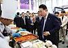 Korean President Yoon Suk Yeol, right, gives a thumbs up after tasting tteokbokki (spicy rice cakes) at a K-food booth at the Korea-Vietnam Partnership Fair at a convention center in Hanoi Thursday. [JOINT PRESS CORPS]