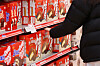 A shopper looks at a pack of Orion's flagship product, the Choco Pie, at a store in Seoul on Feb. 27. [YONHAP]