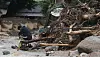 The owner of a house in Yecheon County, North Gyeongsang, slumps to the ground on Sunday morning after coming back to see it destroyed by a landslide. [YONHAP]