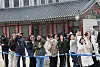 Tourists watch a gatekeeper appointing ceremony at Gyeongbok Palace in central Seoul on March 30 as light snow fell over the capital amid a cold spell. [YONHAP]