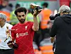 Liverpool's Mo Salah holds the Premier League's Playmaker and Golden Boot trophies after a match against Wolverhampton Wanderers at Anfield in Liverpool on Sunday. [REUTERS/YONHAP]