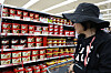 A shopper looks at the different brands of gochujang, or red chili paste, displayed at a supermarket in Seoul on Monday. [NEWS1]
