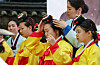 A woman fixes her jokduri, or traditional hair accessory, in a Coming of Age Day event held on the walkway outside of Deoksu Palace in central Seoul on Sunday. The event was held a day before this year's Coming of Age Day, which falls on the third Monday of May. [YONHAP]