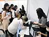 International students line up at a booth at a job fair in Busan on July 20. [YONHAP]
