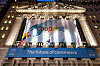 Flags raised ahead of Coupang’s initial public offering in front of the New York Stock Exchange building on Thursday. [JOONGANG ILBO]