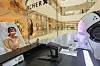 A robot draws a customer at The Hyundai Seoul in Yeouido, western Seoul, on Wednesday. The department store's 'drawing robot' pop-up store on the second floor runs until March 19. [YONHAP]