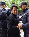 Police officers escort crypto company Terraform Labs founder Do Kwon, center, in Podgorica, Montenegro, Thursday. [EPA/YONHAP]
