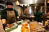 Employees are busy frying and packaging fried chicken at a BB.Q Chicken branch in Mapo District, western Seoul, on Monday. [YONHAP]