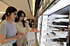 Shoppers look around a display of sunglasses at a duty-free store. [SHINSEGAE]
