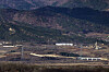 Transmission towers built by South Korea to supply electricity to the now-shuttered inter-Korean Kaesong Industrial Complex in the North Korean border city of Kaesong and a barrier installed by North Korea are visible along the Gyeongui Line road in the western front demilitarized zone (DMZ) on Tuesday amid signs of North Korea preparing to dismantle some of the transmission towers linked to the complex. [YONHAP]