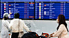 Passengers look at the departure board at Incheon International Airport on Monday, a day before the resumption of visa-free travel to Japan. [YONHAP]
