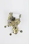 A piece of gilt-bronze shoes that were excavated at the site. The remnants of the shoes were found above the tomb owner's head. [GNIRCH]