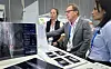ATX Medical Solutions CEO Roger Davis, in the middle, explains SK Telecom's AI veterinary medical service X Caliber to other participants at the Australian Veterinary Association Conference in Melbourne. [SK TELECOM]