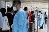People wait in line to get tested for Covid-19 at a testing center in Mapo District, western Seoul, on Monday. [YONHAP]
