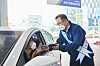 Hyundai Oilbank CEO Kang Dal-ho serves a customer at a branch in Gangnam, southern Seoul, previously owned by SK Networks. [HYUNDAI OILBANK]