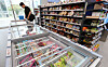 A customer selects an ice cream at a convenience store in Seoul on Sunday. Manufacturers are raising their wholesale prices due to the increase in raw material costs, prompting CU, GS25, 7-Eleven, and Emart24 to announce up to a 25 percent price increase on selected beverages, ice creams, coffee, snacks, and canned goods starting from July. [NEWS1]