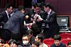 Presidential security officials drag out Rep. Kang Sung-hee of the minor progressive Jinbo Party during a ceremony attended by President Yoon Suk Yeol inaugurating North Jeolla as a special self-governing province at the Sori Arts Center in Jeonju on Thursday. [JOINT PRESS CORPS]