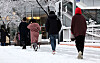 Pedestrians walk on a street covered in snow on Thursday morning in central Seoul. [NEWS1]