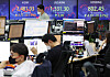 Screens in Hana Bank's trading room in central Seoul show the Kospi closing at 2,481.03 and the Kosdaq at 802.45 on Friday. [YONHAP]