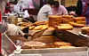 A vendor makes jeon, Korean-style pancakes, at Gwangjang Market in Jongno District, central Seoul, on Wednesday. Palm oil prices are expected to surge as Indonesia, the biggest palm oil producer, banned exports of the oil starting Thursday. Import prices of palm oil crossed the $1,400-per-ton threshold for the first time in March, double the price of 2020. [YONHAP]