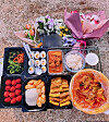 Food and flowers are laid out to commemorate Yoo Ye-na (pseudonym), a woman who took her own life after she aged out of the foster care system, on April 10. [JOONGANG ILBO]