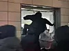 An unidentified man enters the Seoul Western District Court through a broken window in Mapo District, western Seoul, on Jan. 19. [NEWS1]
