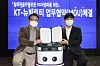 Lee Sang-ho, left, head of KT’s AI Robot business division, and Lee Sang-min, Neubility CEO, pose during a signing ceremony at KT's office building in Songpa District, southern Seoul. [KT]