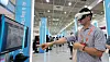 A visitor tries a virtual reality headset displaying a semiconductor production site at Smart Tech Korea 2024 held at Coex in southern Seoul on Wednesday. [NEWS1]