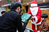 Employees from mobile carrier LG U+ dressed up as Santa Claus and handed out Christmas gifts to children at a child care institution in Yongsan District, central Seoul, on Dec. 19. Pictured above is LG U+ CEO Hong Beom-sik outfitted as Santa handing a present to one of the children. [LGU+]