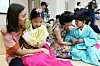 Children thank their teachers with paper carnations for Teacher's Day on May 15 at a daycare center in Gwangju. [YONHAP]