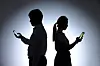 A man and a woman are on their phones [JOONGANG ILBO]