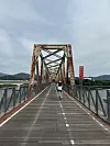 The Bukhangang Railroad Bridge spans the mouth of the Bukhan River on Sept. 27. A former railway bridge converted for cyclists, the bridge is one of the early highlights of the cross-country route. [JIM BULLEY]