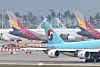 Korean Air Lines' and Asiana Airlines' airplanes parked at Incheon International Airport. [YONHAP]