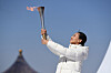 Tai Lihua, head of the China Disabled People's Performing Art Troupe, holds the torch during the Beijing 2022 Paralympic Torch Relay and Flame Lighting Ceremony at the Temple of Heaven park in Beijing, on Wednesday. [XINHUA/YONHAP]