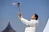 Tai Lihua, head of the China Disabled People's Performing Art Troupe, holds the torch during the Beijing 2022 Paralympic Torch Relay and Flame Lighting Ceremony at the Temple of Heaven park in Beijing, on Wednesday. [XINHUA/YONHAP]