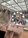 Student reporter Mireia Martinez tries out foundations at Amorepacific’s headquarters in Yongsan District, central Seoul. [RYU JI-HYO]