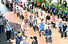 Senior citizens exercise social distancing while waiting in line to receive gift sets containing ginseng chicken soup and fruit. The handouts were provided at a welfare center for seniors in Dalseo District, Daegu, on Thursday. [NEWS1]