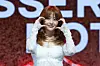 Le Sserafim's Huh Yun-jin poses for photos during a showcase held on March 14 at Yes24 Live Hall in eastern Seoul for the release of its fifth EP “Hot.” [DANIELA GONZALEZ PEREZ]