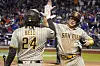 San Diego Padres shortstop Kim Ha-seong, right, celebrates with first baseman Josh Bell after scoring on a hit by Juan Soto against the New York Mets during the eighth inning of Game 3 of the National League Wild Card Series on Oct. 9 in New York. [AP/YONHAP]