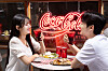 Diners hold glasses of Coca-Cola at a restaurant in Itaewon, Yongsan District, central Seoul, on June 23. [COCA-COLA KOREA]