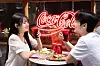Diners hold glasses of Coca-Cola at a restaurant in Itaewon, Yongsan District, central Seoul, on June 23. [COCA-COLA KOREA]