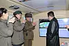North Korean leader Kim Jong-un, right, observes a successful test-fire of a hypersonic glide vehicle on four monitors Tuesday, in a photo released by the state-run KCNA Wednesday. He is accompanied by his younger sister Kim Yo-jong, far left. [KCNA]