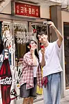 Two people take a selfie outside a restaurant themed around Coca-Cola in Itaewon, Yongsan District, central Seoul, on June 23. [COCA-COLA KOREA]
